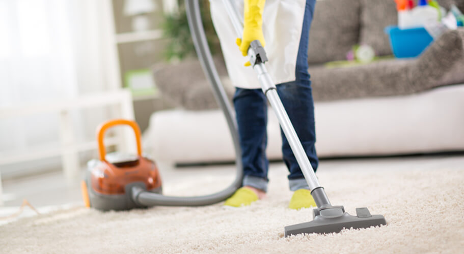 Lounge room carpet being vacuumed during a regular clean
