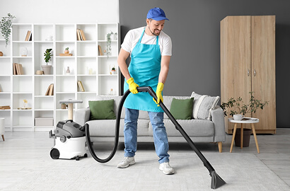 Lounge and living area being vacuumed during a deep clean